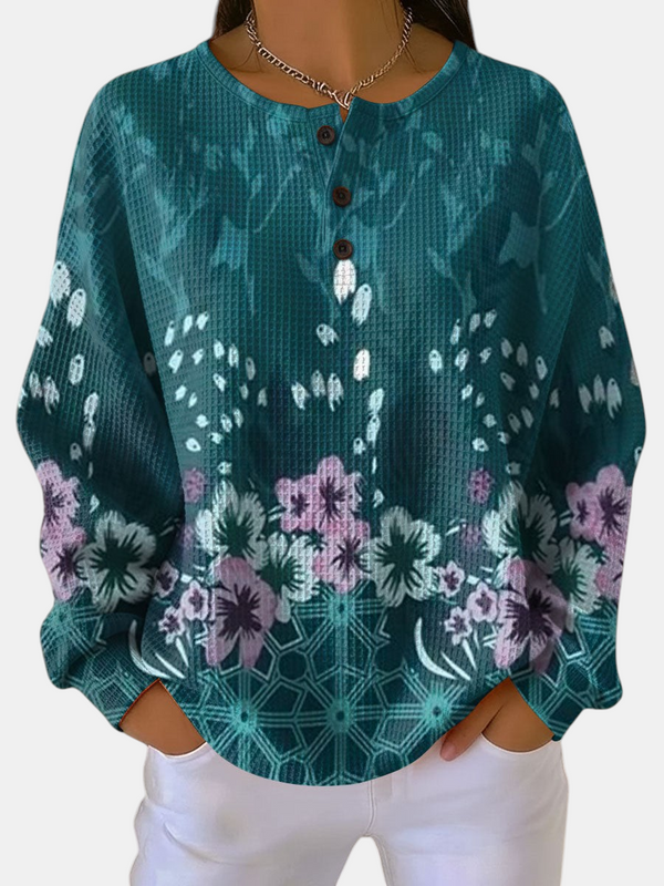 Emma Genève pull Nora à motif floral bleu sarcelle avec texture gaufrée et boutons sur le col
