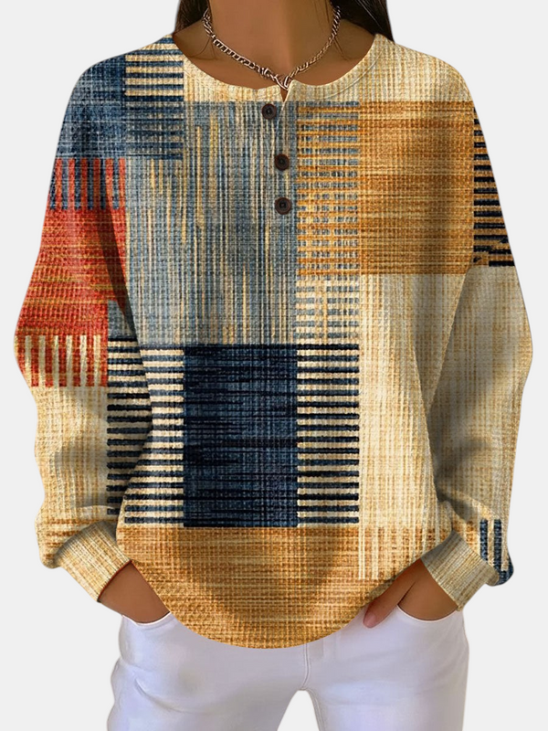 Sweat Emma Genève Thea à motif géométrique multicolore, col rond boutonné et coupe féminine confortable.